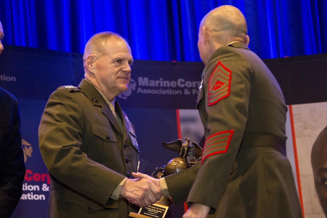 Commandant of the Marine Corps Gen. Robert B. Neller congratulates a Marine during the 12th Marine Corps Association and Foundation Ground Logistics Awards dinner at the Crystal Gateway Marriot, Arlington, Va., March 24, 2016. The annual event recognized the professional achievements of the top performing Marine logisticians and logistics unit of the year for the previous year. (U.S. Marine Corps photo by Staff Sgt. Gabriela Garcia/Released)