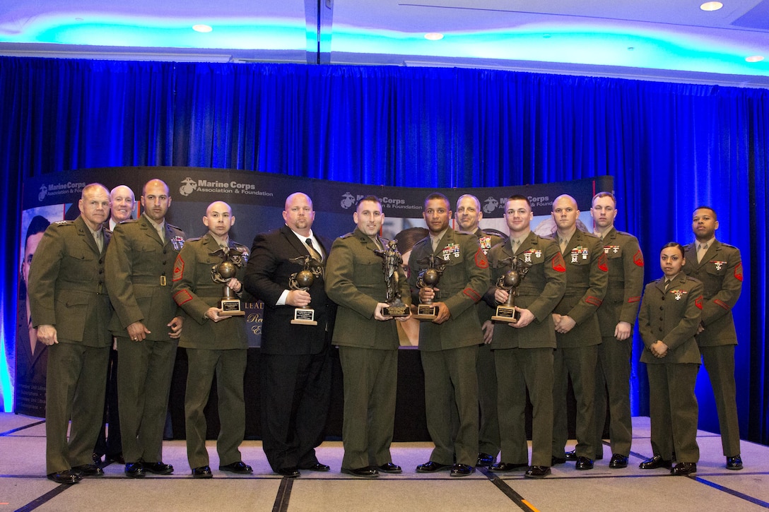 Commandant of the Marine Corps Gen. Robert B. Neller poses with the 12th Marine Corps Association and Foundation Ground Logistics awardees at the Crystal Gateway Marriot, Arlington, Va., March 24, 2016. The annual event recognized the professional achievements of the top performing Marine logisticians and logistics unit of the year for the previous year. (U.S. Marine Corps photo by Staff Sgt. Gabriela Garcia/Released)