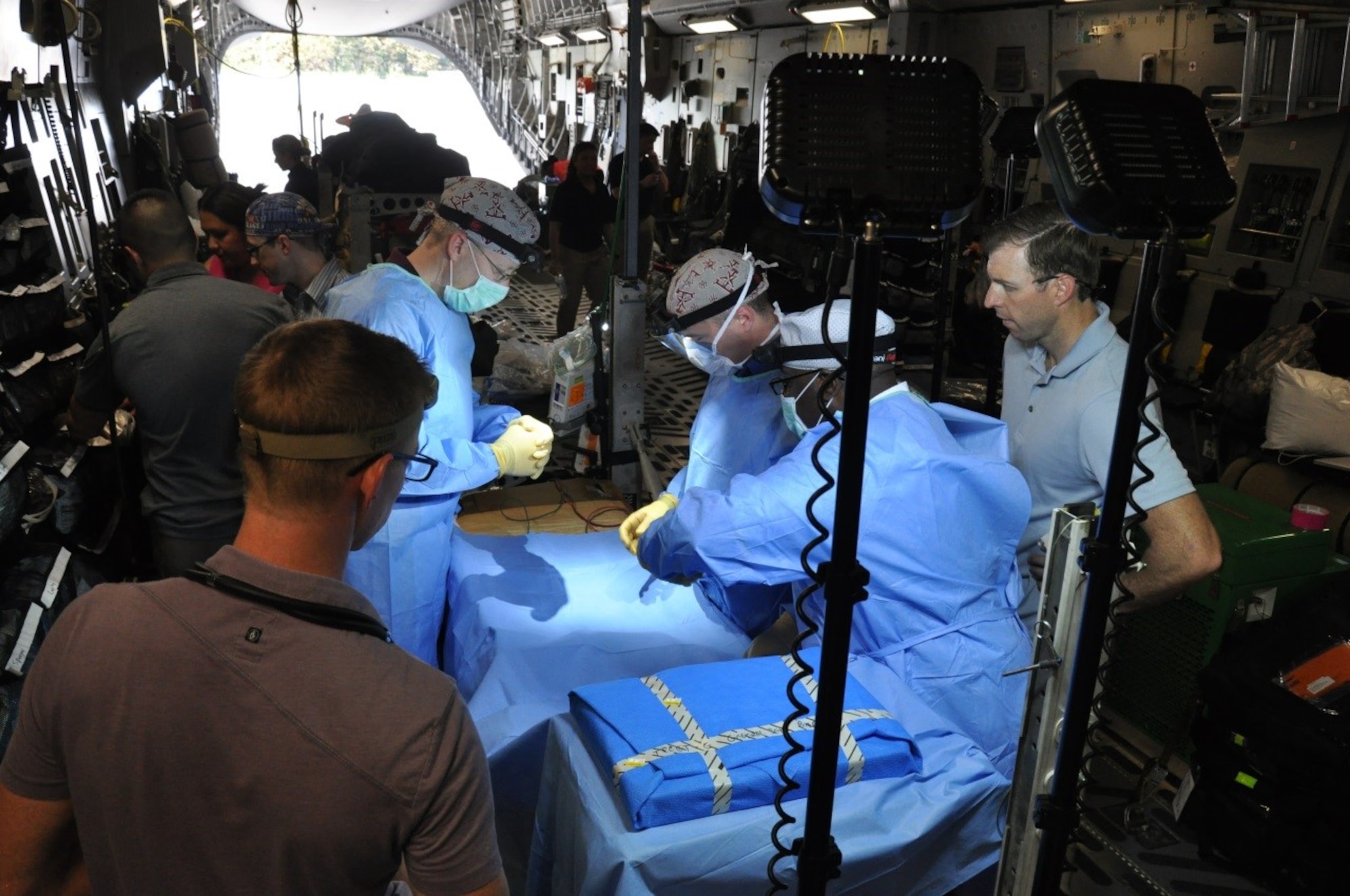 Medics from the 59th Medical Wing conduct a medical training exercise inside a C-17 Globemaster III on March 18, 2016, at the Havana International Airport, Cuba. A Tactical Critical Care Evacuation Team-Enhanced and a Critical Care Air Transport Team from the wing supported the first presidential visit to Cuba in nearly 90 years. The teams -- wearing civilian clothes for security -- were part of Defense Department, White House and State Department emergency response systems. (U.S. Air Force photo/Maj. Howard Blackwell)
