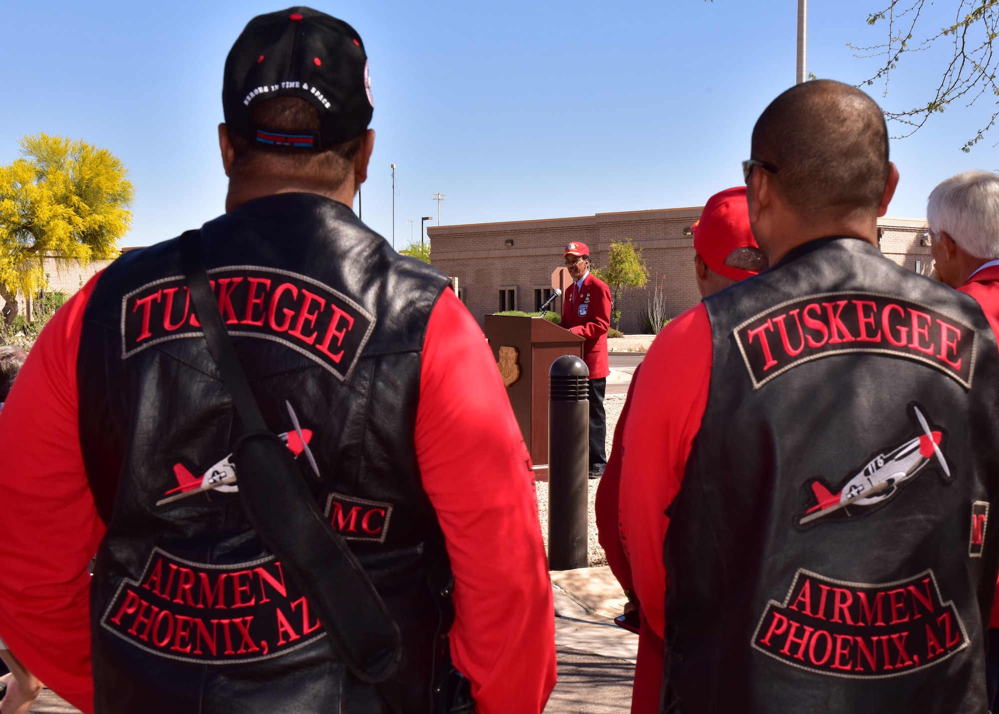 Mr. Bernard Bruce, 56th Fighter Wing occupational safety manager and Archer-Ragsdale Arizona Chapter of Tuskegee Airmen historian, speaks Mar. 24 during the 3rd Annual Tuskegee Airmen Commemoration Day, while supporters look on at Luke Air Force Base, Ariz. (U.S. Air Force photo by Tech. Sgt. Louis Vega Jr.) #Tuskegee75