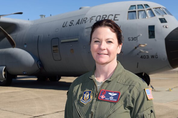 Lt. Col. Kaitlyn Woods, 53rd Weather Reconnaissance Squadron aerial reconnaissance weather officer, poses in front of WC-130J Hurricane Hunter aircraft March 13, 2016, at Keesler Air Force Base, Mississippi. The major has served as an ARWO for the Hurricane Hunters for 10 years, flying with the squadron to collect storm data for the National Hurricane Center. (U.S. Air Force photo/Tech. Sgt. Ryan Labadens)