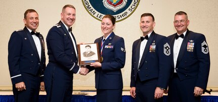 Senior Airman Kathryn Raethel, 437th Operations Support Squadron, is awarded the John L. Levitow award from Col. Rob Lyman, Joint Base Charleston commander, March 24, 2016, at the Charleston Club on JB Charleston – Air Base, S.C. The John L. Levitow award is given for a student’s exemplary demonstration of excellence, both as a leader and a scholar. (U.S. Air Force photo by Senior Airman Clayton Cupit)