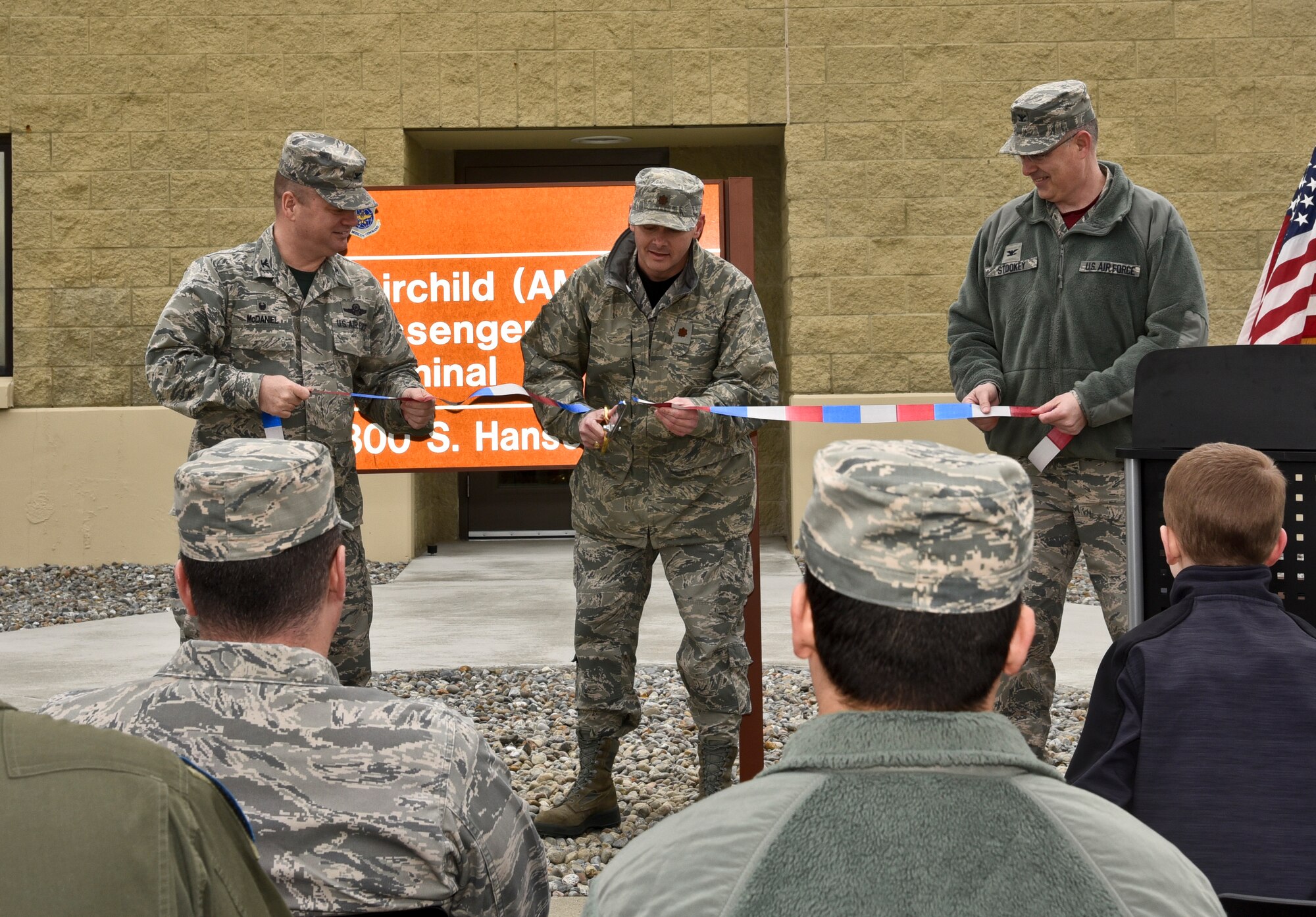 Col. Brian McDaniel, 92nd Air Refueling Wing commander, Maj. Lance Vann, 92nd Logistics Readiness Squadron commander, and Col. David Stookey, 92nd Mission Support Group commander, cut the ribbon during the opening of the new Passenger Terminal  March 25, 2016, at Fairchild Air Force Base, Wash. “As we dedicate this new facility and consolidate operations in building 2090, the 92nd LRS willfully accepts this charge and strives to provide customer service by which all other units are measured,-- Maj. Lance Vann. (U.S. Air Force photo/Airman 1st Class Taylor Bourgeous)  