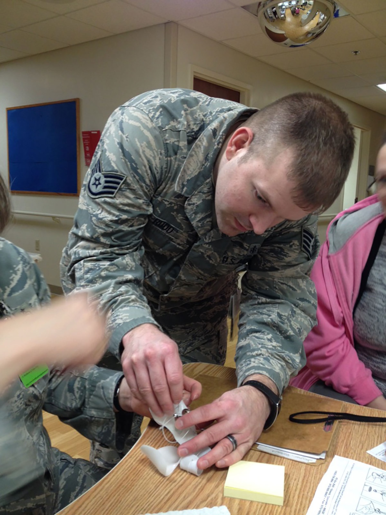 Air Force Staff Sgt. Devin Rudd, 673d Medical Operations Squadron physical medicine technician, creates a dynamic splint at the Joint Base Elmendorf-Richardson hospital Feb. 26, 2016. The splint was for Air Force Master Sgt. Robert Wagner, 773d Civil Engineer Squadron primary security manager, after he injured his right hand middle finger while playing intramural soccer as a goalie. (Courtesy Photo)