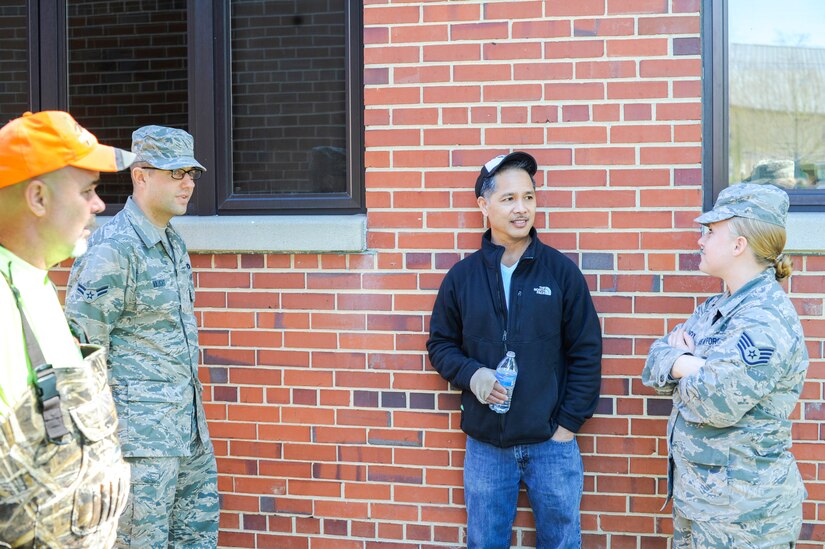 Mr. John Noble (center), 11th Civil Engineer Pest Management supervisor, discusses the importance of feral cat control on Joint Base Andrews, Md., March 24, 2016. Feral cats can threaten health and welfare as they may carry rabies. (U.S. Air Force photo by Senior Airman Ryan J. Sonnier/RELEASED)