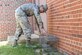 Airman 1st Class Conner Vaught, 11th Civil Engineer Pest Management apprentice, sets a live-trap for feral cats on Joint Base Andrews, Md., March 24, 2016. Feral cats have the potential to carry rabies, causing health issues. (U.S. Air Force photo by Senior Airman Ryan J. Sonnier/RELEASED)