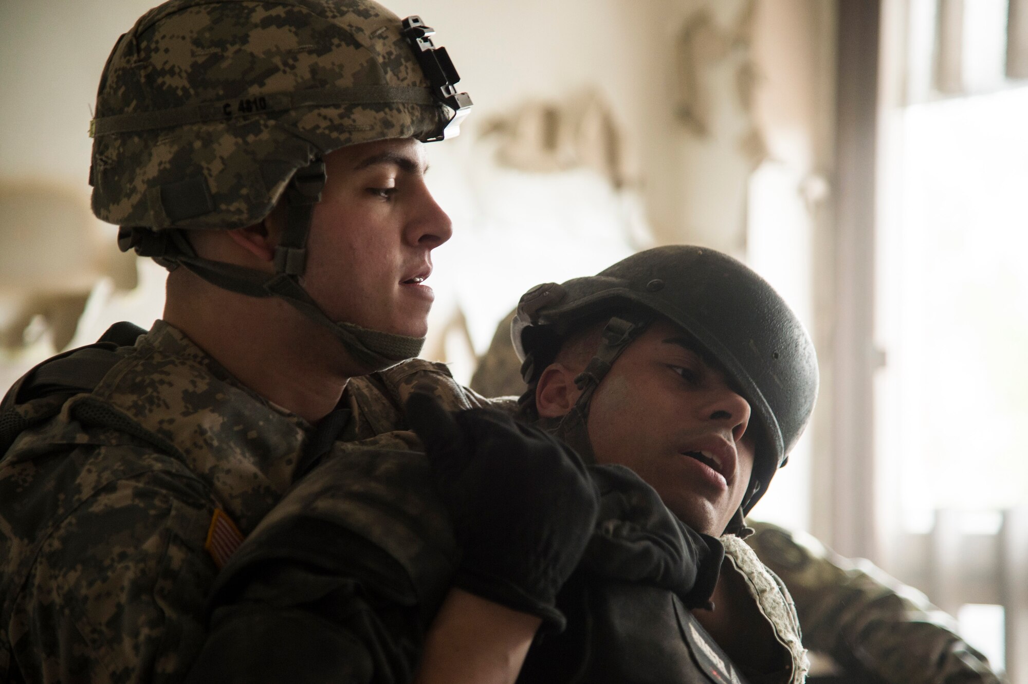U.S. Army Spc. Matthew Cavey, 529th Regimental Support Company radio and Communications Security repairer, pulls Staff Sgt. Gabriell Viera, 811th Security Forces Squadron executive aircraft security team leader, from a room during the Tactical Combatives Course, a class conducted by the U.S. Army Combatives School, March 22, 2016. The course allows service members to get realistic training without compromising their safety. (U.S. Air Force photo by Senior Airman Mariah Haddenham/released)