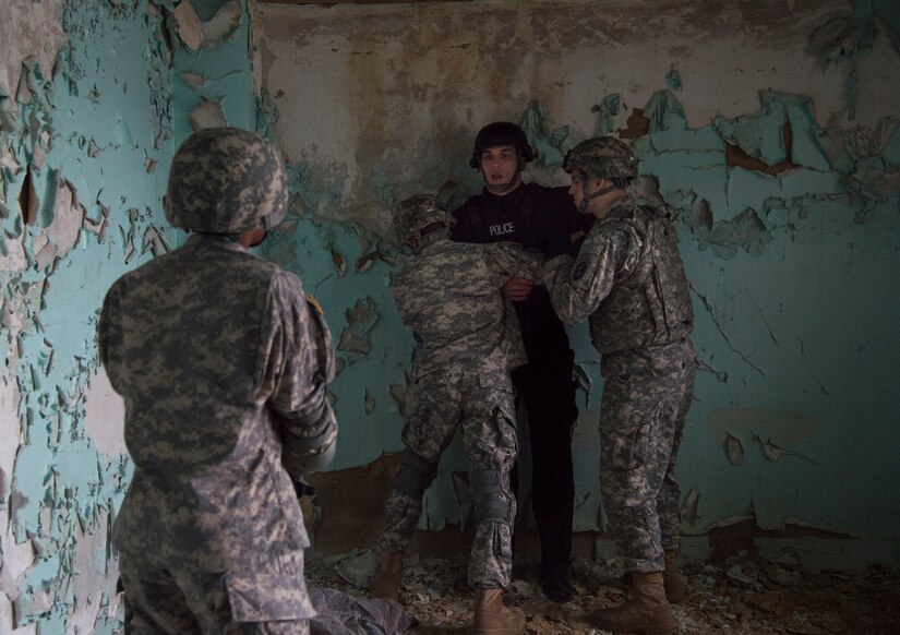 Senior Airman William Schuld, 11th Security Forces Squadron Emergency Services Team operator, is apprehended during training at the Tactical Combatives Course, a class conducted by the U.S. Army Combatives School, March 22, 2016.The course allows service members to get  realistic training without compromising their safety. (U.S. Air Force photo by Senior Airman Mariah Haddenham/released)
