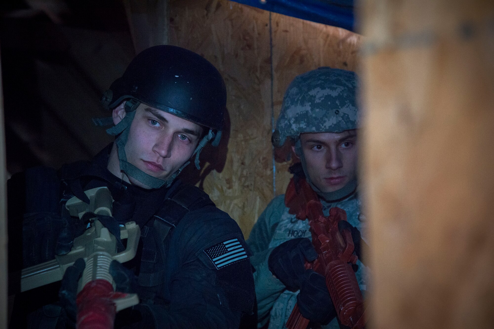 Senior Airman William Schuld, 11th Security Forces Squadron Emergency Services Team operator (left),  and Senior Airman David Hoch, 11th Security Forces Squadron response force leader, prepare to clear a room during the Tactical Combatives Course, a class conducted by the U.S. Army Combatives School, March 22, 2016. Any service member who wishes to participate in the course just needs to provide their most recent physical fitness assessment, fill out a safety questionnaire, and complete a combatives injury screening form. (U.S. Air Force photo by Senior Airman Mariah Haddenham/released)