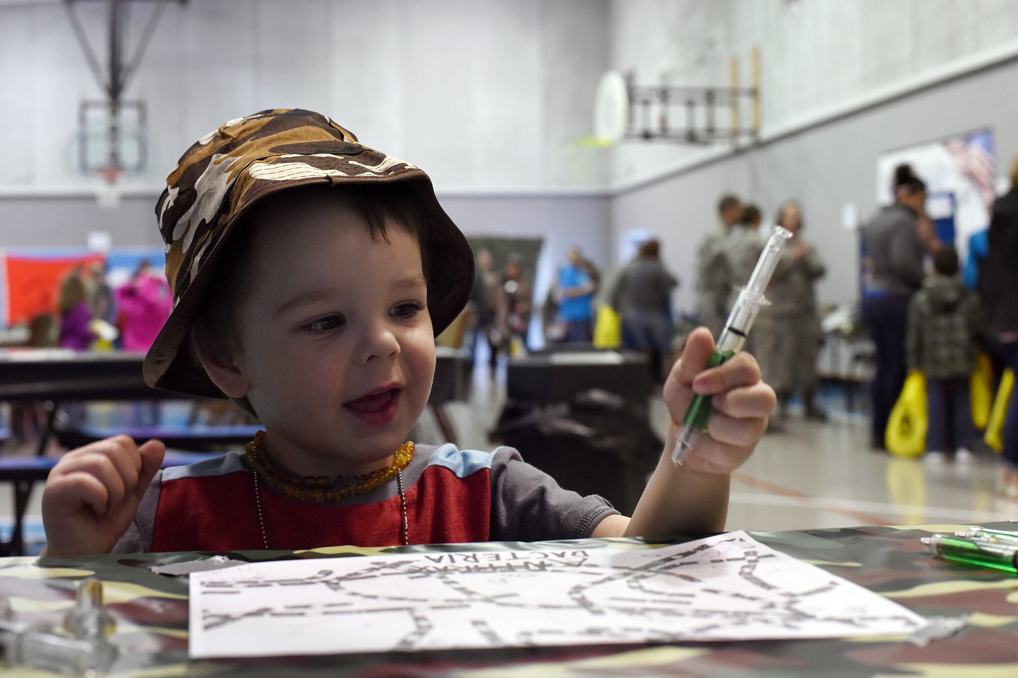Barrett Latham, son of Senior Airman Thomas Latham, 341st Logistics Readiness Squadron traffic manager representative, signs his name at a junior deployment line March 23, 2016, at Malmstrom Air Force Base, Mont. The 341st Force Support Squadron hosted the event to give children like Barrett a chance to see what their parents go through before deploying. (U.S. Air Force photo/Senior Airman Jaeda Tookes) 