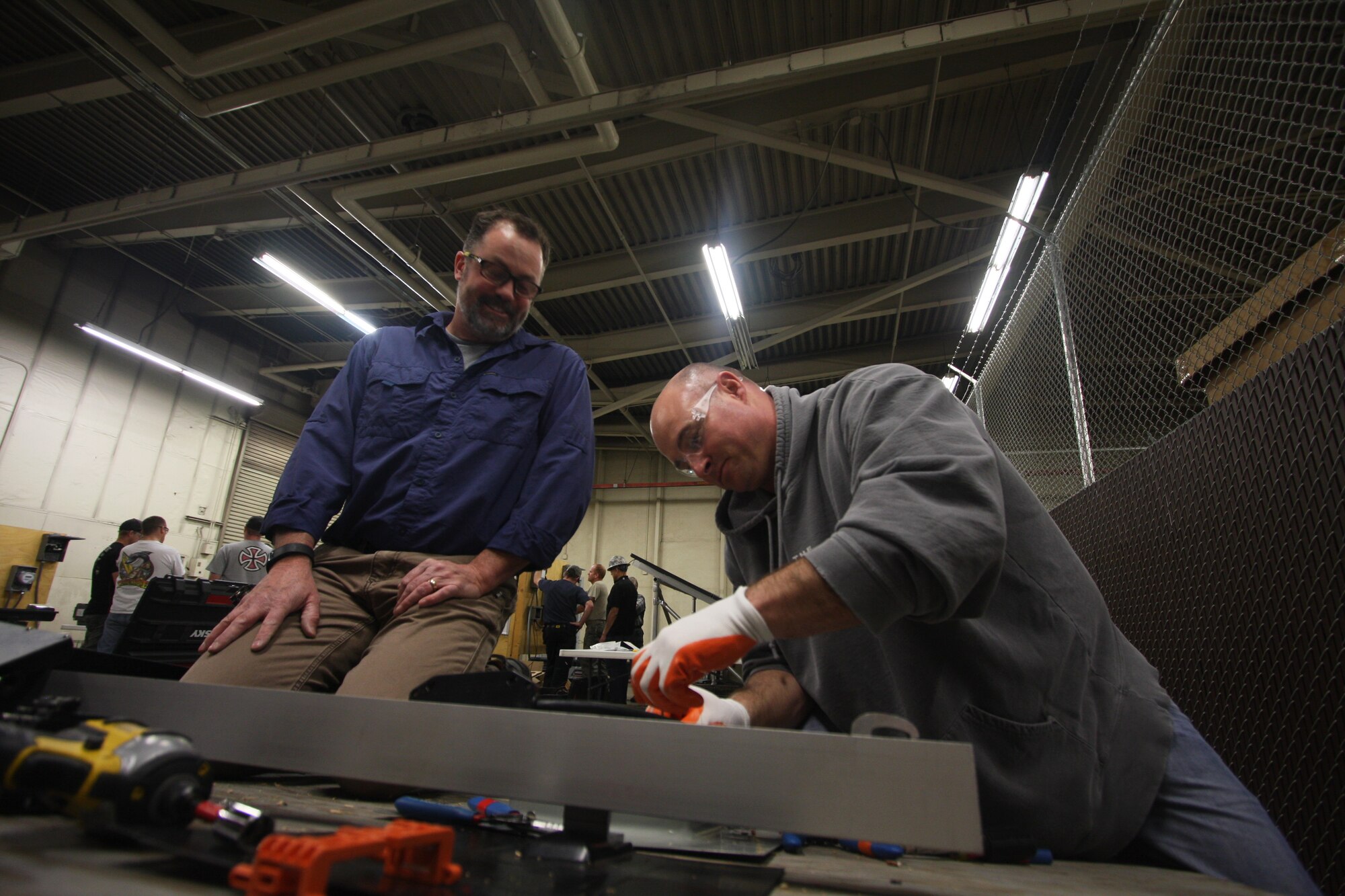 Master Sgt. Robert Hollenbaugh, 75th Security Forces Squadron, connects an electrical circuit to install solar panels on a solar array during the hands on training portion of the first Air Force cohort of the Solar Ready Vets program. Program participants graduated March 25 and are now certified to design, install and troubleshoot solar systems. (U.S. Air Force photo by Crystal Young)