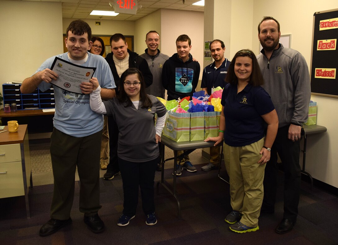 On March 15, 2016, students and faculty from the A.C.H.I.E.V.E. young adult special needs education program in Council Rock School District, Newtown, Pa. stand by baby shower gifts bound for the upcoming Moms-To-Be Celebration. The gift bags, brimming with stuffed animals and small hygiene items were a hit at the celebration in Valley Forge, Pa. on March 19. (U.S. Air National Guard photo by Master Sgt. Christopher Botzum)