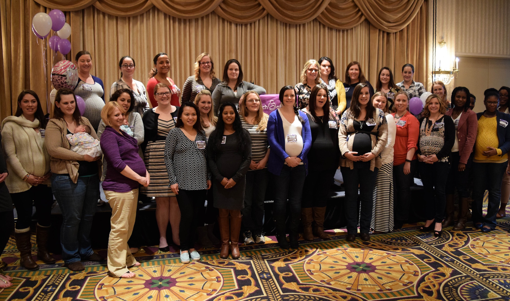Attendees at the Pennsylvania March of Dime’s Moms-To-Be Celebration on March 19, 2016 gather at the close for a group photo. The event, held at the Valley Forge Casino Resort in Valley Forge, Pa. showered more than 40 expecting military women or military spouses with gifts and provided them with information on benefits available to them. (U.S. Air National Guard photo by Master Sgt. Christopher Botzum)