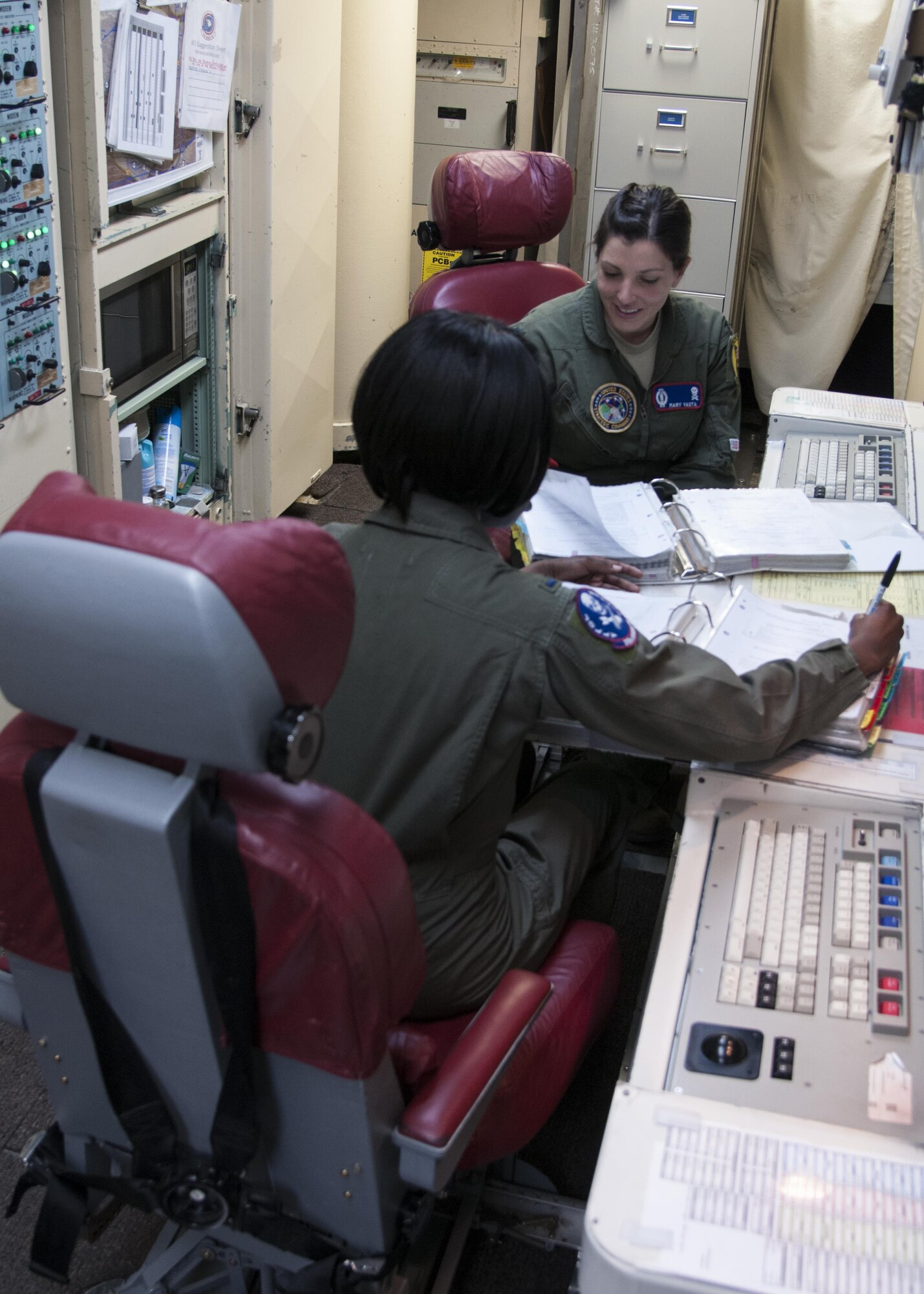 1st Lt. Mary Vasta, 319th Missile Squadron combat crew commander, reviews information with 1st Lt. Krystal Wilder, 319th MS combat crew deputy, in a launch control center, March 22, 2016, in the F.E. Warren Air Force Base, Wyo., missile complex. Ninety female missileers, within 20th Air Force and Task Force-214 performed alert for the first ever all-female alert. (U.S. Air Force photo by Airmen 1st Class Malcolm Mayfield)
