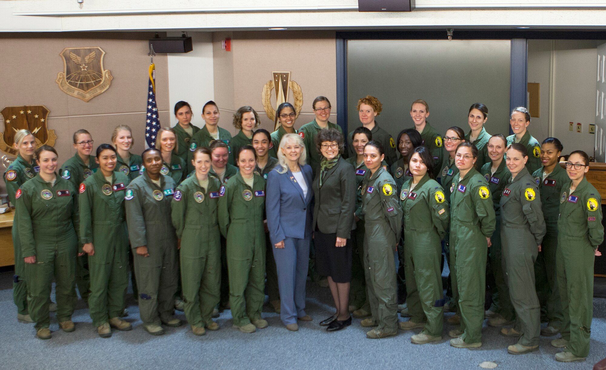 Missileers from the 90th Operations Group and Retired Col. Pat Fornes, the first female officer on a U.S. missile crew and the first female missile squadron commander; and Retired Col. Linda Aldrich, first female Minuteman ICBM crew member pose for a group photo on F.E. Warren Air Force Base, Wyo., March 22, 2016. In commemoration of Women's History Month, 90 all-female missileers within 20th Air Force pulled a 24-hour alert. (U.S. Air Force photo by Lan Kim)