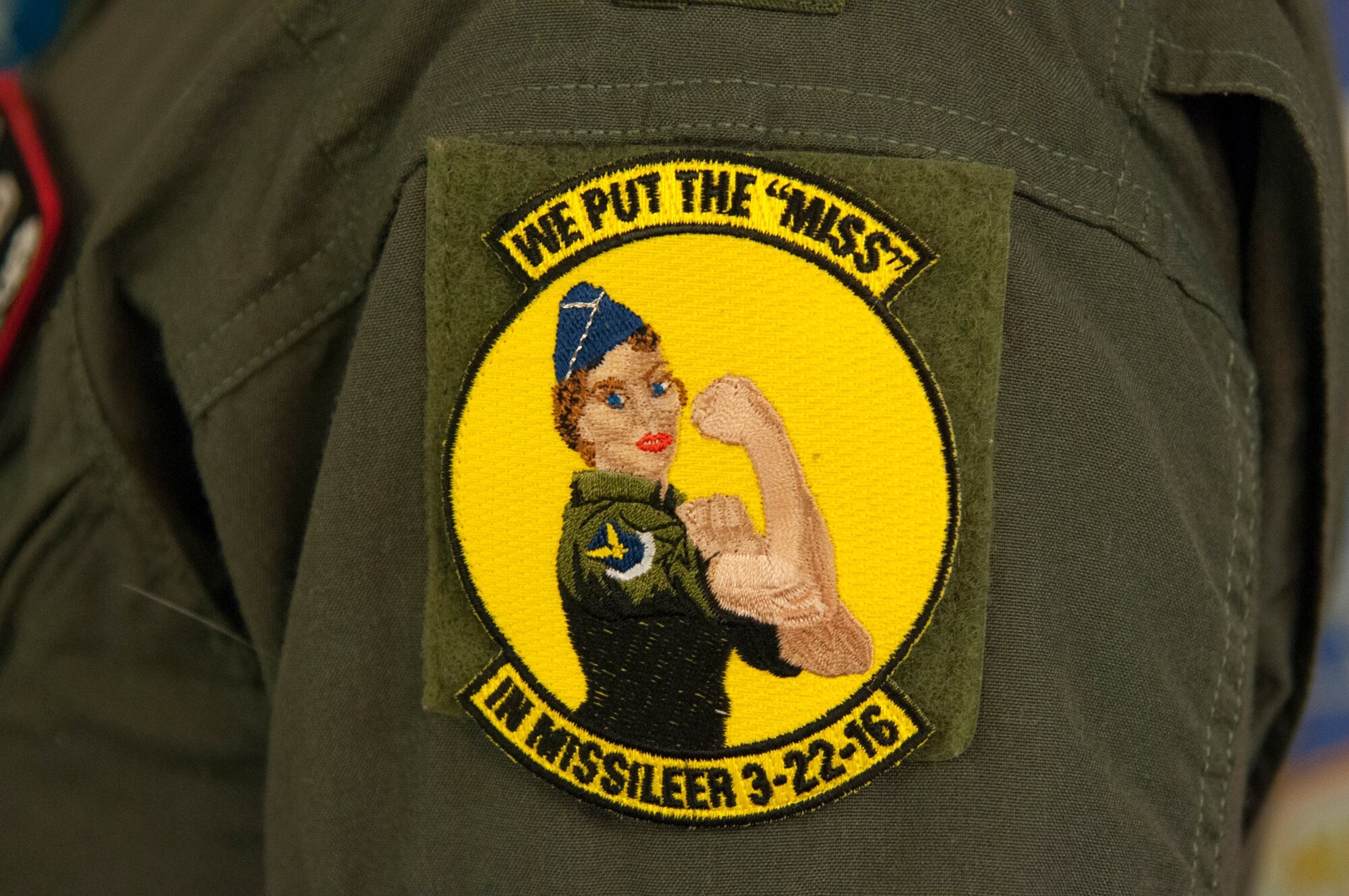 A 320th Missile Squadron missileer shows-off a patch March 22, 2016, on F.E. Warren AFB, Wyo. The 90th MW joined 20th Air Force's ICBM wings by conducting the first-ever all female alert in honor of Women’s History Month.  (U.S. Air Force photo by Senior Airman Jason Wiese)