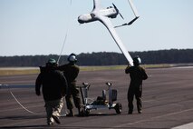 Marines with Marine Unmanned Aerial Vehicle Squadron 2 retrieve a RQ-21A Blackjack after recovery at Marine Corps Air Station Cherry Point, N.C., March 21, 2016. The RQ-21A Blackjack system is modular, flexible and multi-mission capable, providing roll-on, roll-off transitions between land and maritime environments. The aircraft was launched for the first time into Class D airspace over MCAS Cherry Point. (U.S. Marine Corps photo by Pfc. Nicholas P. Baird/Released)