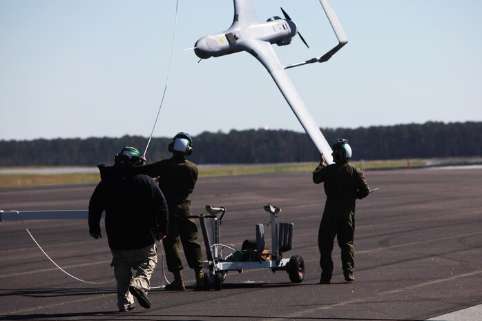 Marines with Marine Unmanned Aerial Vehicle Squadron 2 retrieve a RQ-21A Blackjack after recovery at Marine Corps Air Station Cherry Point, N.C., March 21, 2016. The RQ-21A Blackjack system is modular, flexible and multi-mission capable, providing roll-on, roll-off transitions between land and maritime environments. The aircraft was launched for the first time into Class D airspace over MCAS Cherry Point. (U.S. Marine Corps photo by Pfc. Nicholas P. Baird/Released)