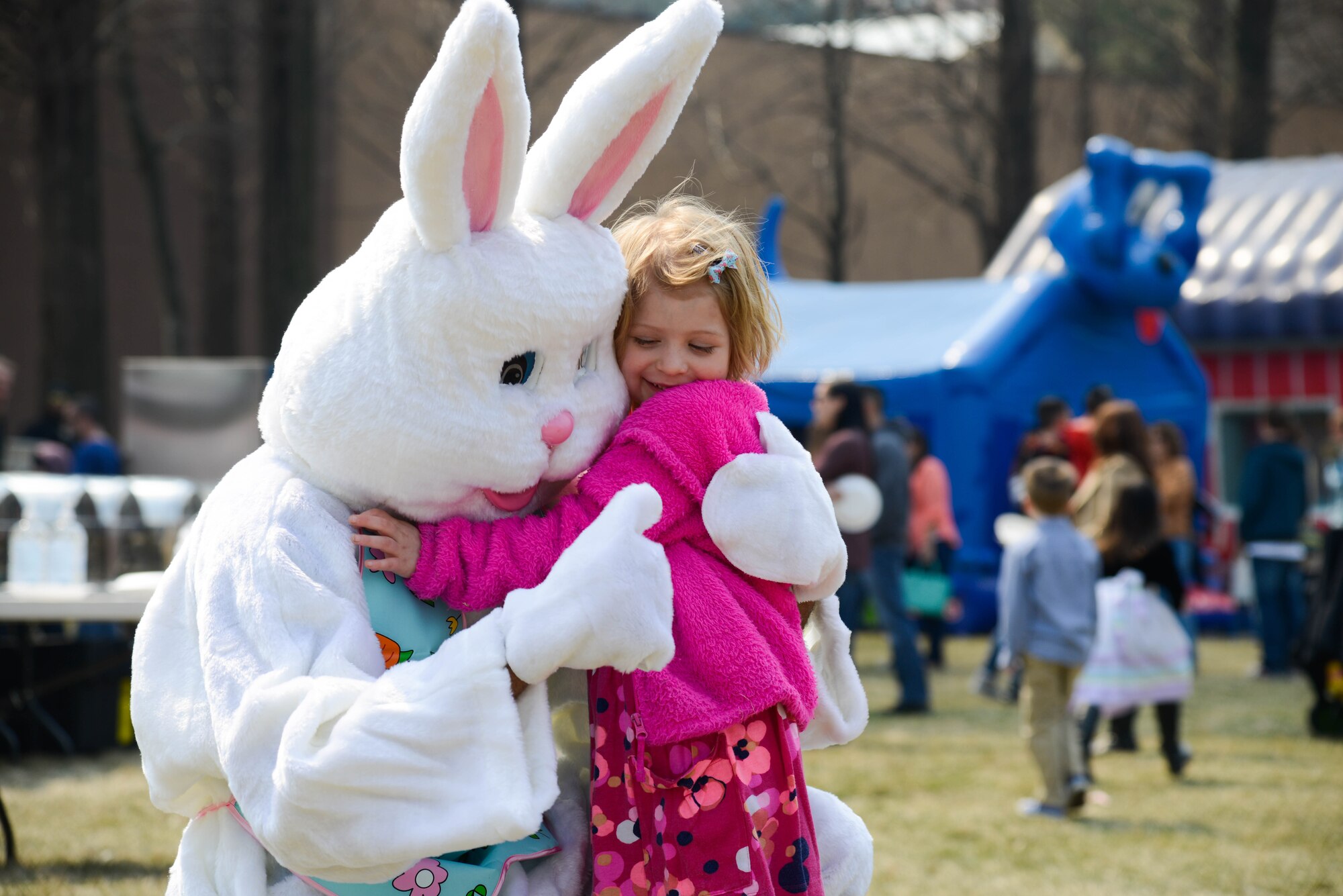 A child hugs the Easter Bunny during the annual Easter egg hunt March 26, 2016, at Osan Air Base, Republic of Korea. Children participated in inflatable rides, bag races and cotton candy during the day’s events. (U.S. Air Force photo by Senior Airman Dillian Bamman/Released)