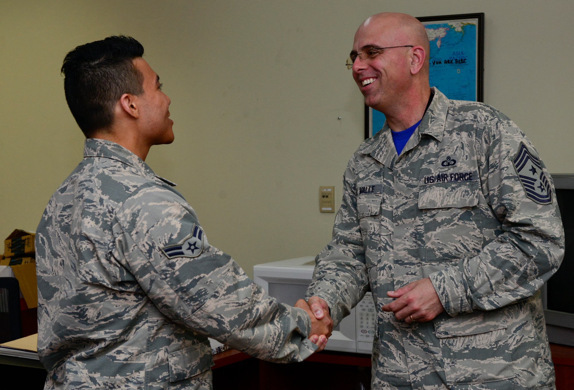 Airman 1st Class Jon Yulan, 51st Operations Support Squadron administration support technician, greets Chief Master Sgt. Alex Del Valle, 51st Fighter Wing command chief, during the chief’s immersion tour with the 51st Operations Group on Osan Air Base, Republic of Korea , March 25, 2016. The immersion tour allowed Del Valle to get a deeper understanding of the employment of the Airmen across the base. (U.S. Air Force photo by Senior Airman Kristin High/Released)