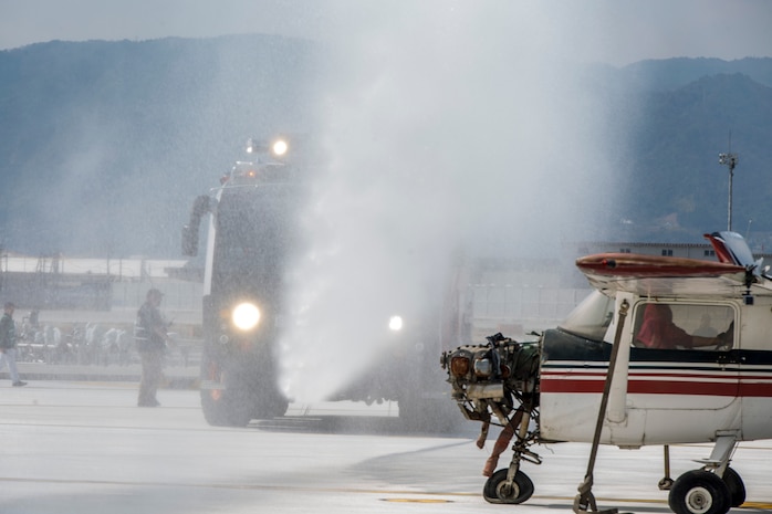 Aircraft Rescue Firefighter Marines with Headquarters and Headquarters Squadron extinguish a simulated fire during the Mass Casualty Exercise 2016 at Marine Corps Air Station Iwakuni, Japan, March 23, 2016. Conducted in preparation for the Japan Maritime Self-Defense Force/MCAS Iwakuni Friendship Day 2016 Air Show, the exercise simulated a dual aircraft collision where large crowds will be expected. To make the exercise more realistic, first responders did not know when, where or what would happen. The exercise helps responders maintain situational readiness and ensure the safety of personnel on the air station. (U.S. Marine Corps photo by Lance Cpl. Aaron Henson/Released)