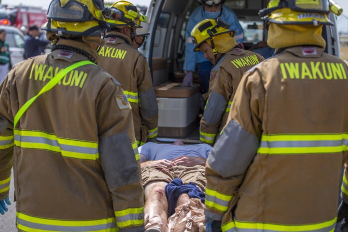 Iwakuni City firefighters carry a casualty to an ambulance during the Mass Casualty Exercise 2016 at Marine Corps Air Station Iwakuni, Japan, March 23, 2016. Conducted in preparation for the JMSDF/MCAS Iwakuni Friendship Day 2016 Air Show, the exercise simulated a dual aircraft collision where large crowds will be expected. The JMSDF participated in the exercise to enhance bilateral cooperation with U.S. first responders, establish safety measures and maintain situational readiness.  To make the exercise more realistic, first responders did not know when, where or what would happen. After evaluating last year’s exercise, more residents participated in the exercise as actors and selected as either a casualty or bystander. (U.S. Marine Corps photo by Lance Cpl. Aaron Henson/Released)
