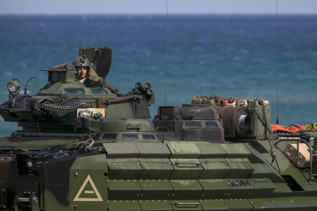 A U.S. Marine operates an AAV7A1 tracked vehicle after landing on a beach during an amphibious assault mission, part of exercise Ssang Yong 16 near Pohang, South Korea, March 12, 2016. Marine Corps photo by Lance Cpl. Sean M. Evans