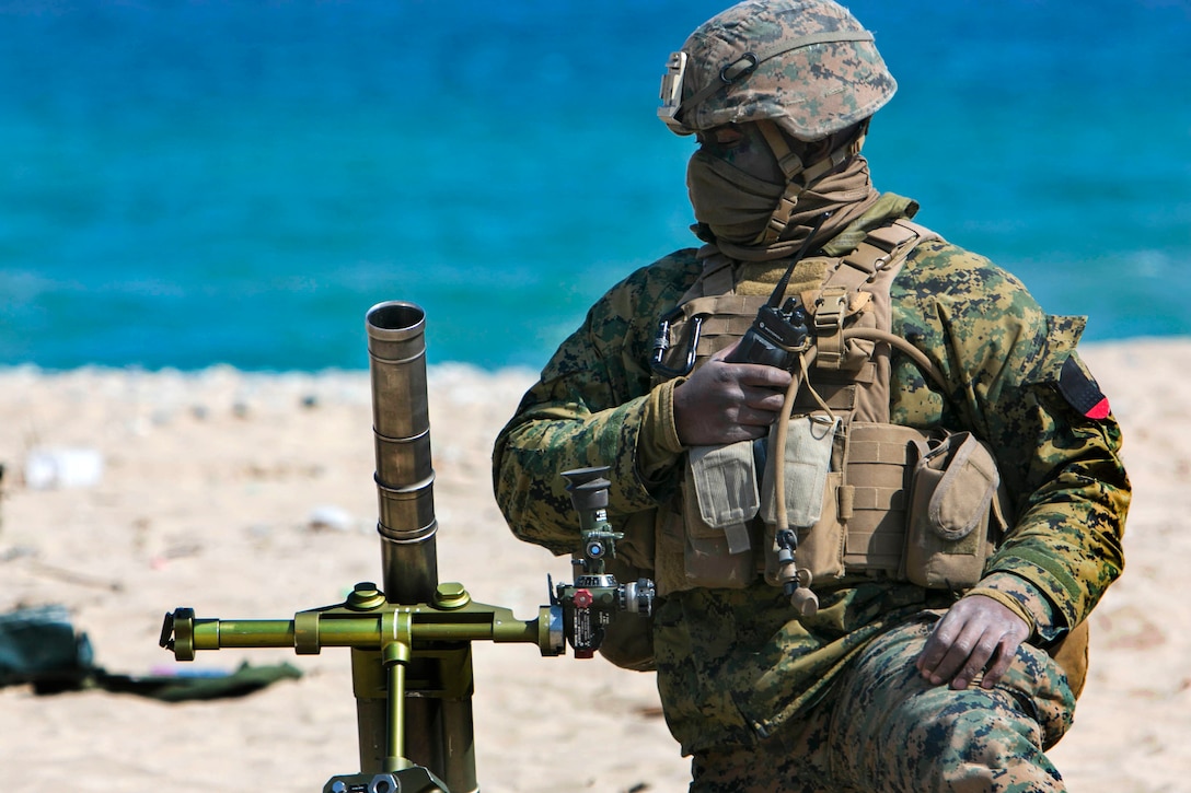 Marine Corps Lance Cpl. Valmor Johnson sets up a mortar system on a beach during exercise Ssang Yong 16 near Pohang, South Korea, March 12, 2016. Johnson is a mortarman assigned to Echo Company, 2nd Battalion, 1st Marine Regiment. Marine Corps photo by Lance Cpl. Sean M. Evans