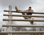 Sgt. John G. Finken, a Johnston, Iowa resident and military police officer with the 186th Military Police Company at Camp Dodge, Johnston, Iowa climbs an obstacle as part of a course during the Iowa Army National Guard Best Warrior Competition at Camp Dodge, Johnston, Iowa, on March 20. Finken placed first out of 14 sergeants and staff sergeants who competed for the Non-Commissioned Officer of the Year title over three days of challenges testing the Soldiers’ physical, mental and professional skills. 