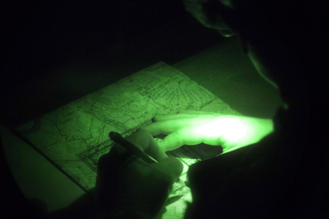 Army Sgt. 1st Class Nelson plots points on a map as part of the night land navigation course during the 2016 Best Warrior competition at Fort Knox, Ky., March 22, 2016. Molinarez is assigned to the Army Reserves Career Division. Army photo by Spc. Gabriel Prado