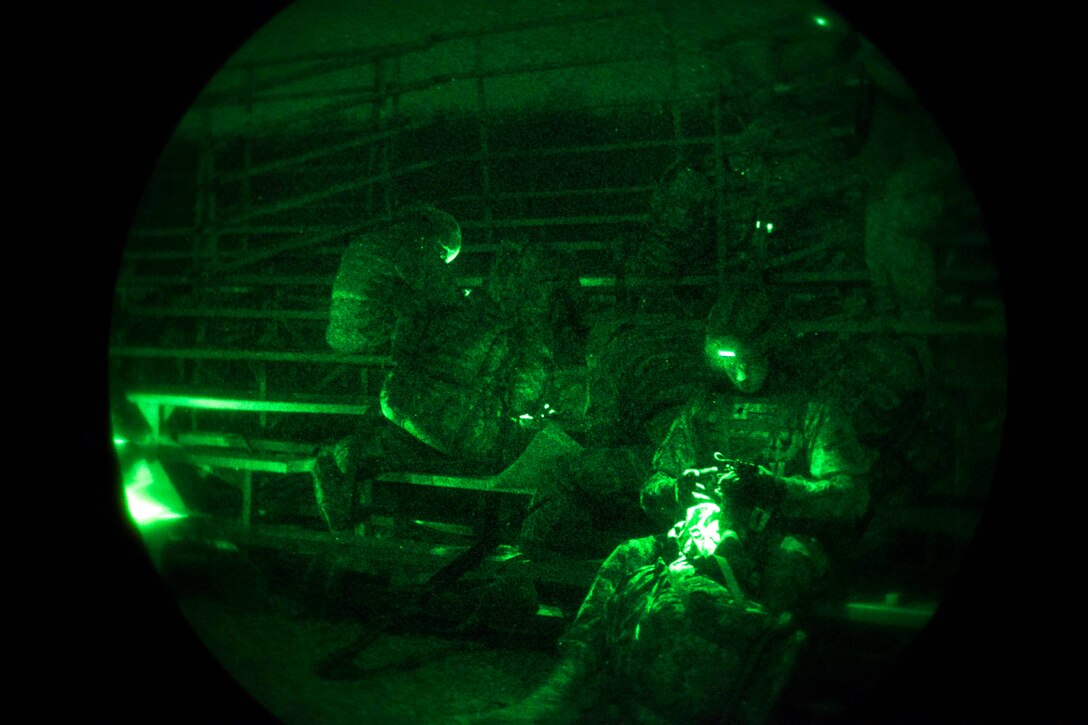 Army Sgt. Angel Saurezelias, right, participates in the night land navigation portion of the Best Warrior competition at Fort Knox, Ky., March 22, 2016. Saurezelias is assigned to the 8th Battalion 229th Aviation Regiment. Army photo by Spc. Gabriel Prado