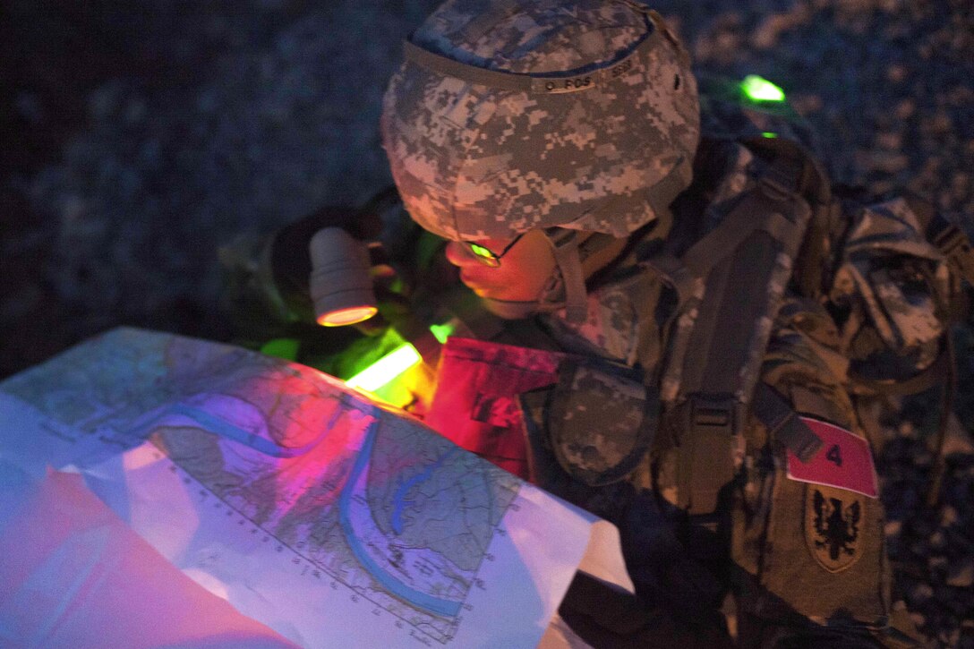 Army Sgt. Angel Hunter checks points on a map during the night land navigation portion of the Best Warrior competition at Fort Knox, Ky., March 22, 2016. Hunter is assigned to the 90th Aviation Support Battalion. Army photo by Spc. Gabriel Prado 