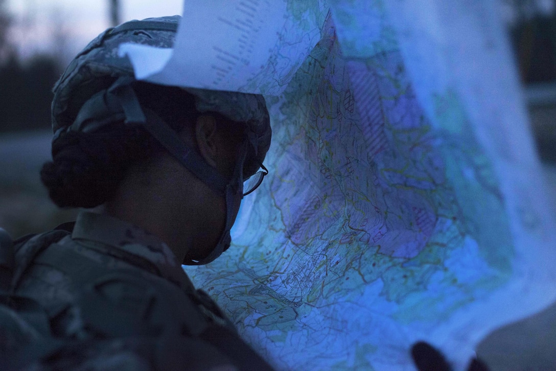 Army Sgt. Angel Hunter checks a map while participating in the night land navigation portion of the Best Warrior competition at Fort Knox, Ky., March 22, 2016. Hunter is assigned to the 90th Aviation Support Battalion. Army photo by Spc. Gabriel Prado