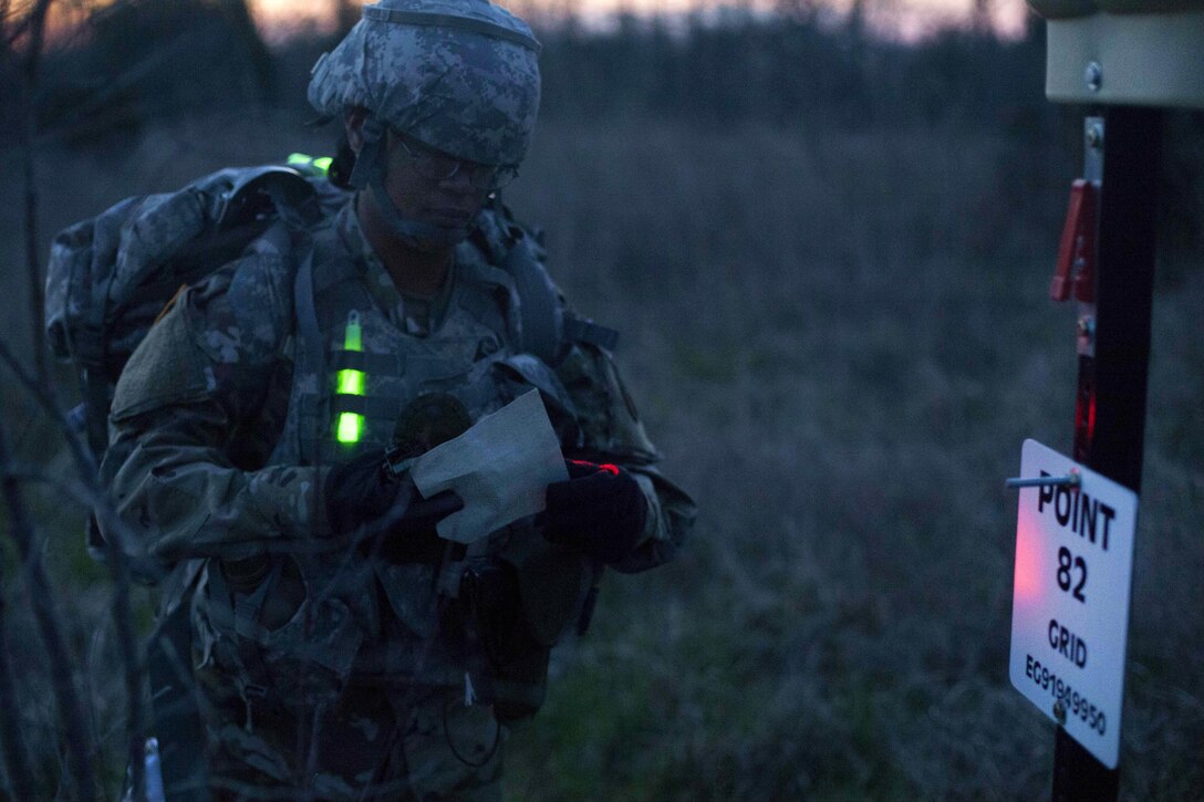 Army Sgt. Angel Hunter arrives at checkpoint 82 during the night land navigation portion of the Best Warrior competition at Fort Knox, Ky., March 22, 2016. Army photo by Spc. Gabriel Prado