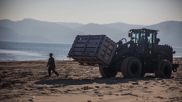 A U.S. Marine with Combat Logistics Battalion 31, 31st Marine Expeditionary Unit ground guides a Tractor, Rubber-tired Articulated, Multi-purpose vehicle to load equipment onto a Landing Craft Air Cushion assigned to Naval Beach Unit 7 during Exercise Ssang Yong 16, Dogu Beach, Pohang, South Korea, March 17, 2016. Ssang Yong 16 is a biennial combined amphibious exercise conducted by U.S. forces with the Republic of Korea Navy and Marine Corps, Australian Army and Royal New Zealand Army forces in order to strengthen interoperability and working relationships across a wide range of military operations. The Marines and sailors of the 31st MEU are currently deployed aboard the Bonhomme Richard Amphibious Ready Group as part of their spring deployment of the Asia-Pacific region.