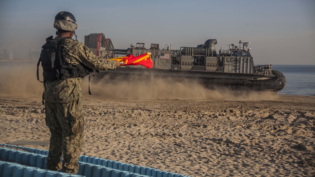 U.S. Navy sailor Seaman Joshua Hall, Naval Beach Party, Naval Beach Unit 7  signals a Landing Craft Air Cushion assigned to NBU 7 during Exercise Ssang Yong 16, Dogu Beach, Pohang, South Korea, March 17, 2016. Ssang Yong 16 is a biennial combined amphibious exercise conducted by U.S. forces with the Republic of Korea Navy and Marine Corps, Australian Army and Royal New Zealand Army forces in order to strengthen interoperability and working relationships across a wide range of military operations. The Marines and sailors of the 31st MEU are currently deployed aboard the Bonhomme Richard Amphibious Ready Group as part of their spring deployment of the Asia-Pacific region. 