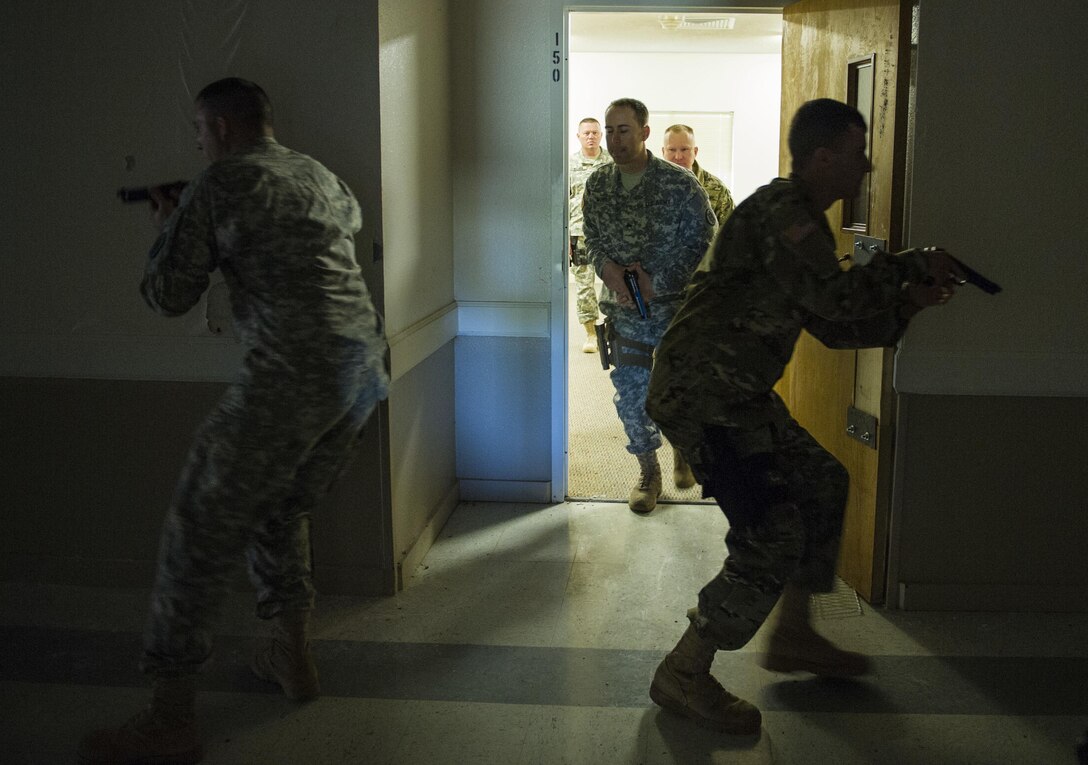 U.S. Army Reserve Soldiers from the 607th Military Police Battalion, of the 200th MP Command, tactically exit a cleared room during a two-day joint training exercise conducted by the Grand Prairie Police Department in Mansfield, Texas, March 24. More than 15 service members, including Marines from the same Reserve Center, partnered to share and learn police tactics and techniques. (U.S. Army photo by Staff Sgt. Shejal Pulivarti)