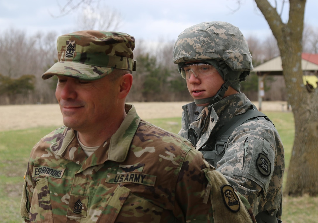 Army Spc. Ethan Estabrooks, a helicopter crew chief and mechanic with the Iowa Army National Guard’s Charlie Company, 2nd Battalion, 147th Aviation Regiment, performs a search on his sponsor and father, 1st Sgt. Gary Estabrooks, at the Iowa Best Warrior Competition at Camp Dodge in Johnston, Iowa, March 19, 2016. After the three-day event, one noncommissioned officer and one junior enlisted soldier were selected to represent Iowa in May’s regional Best Warrior Competition in Ohio. Iowa Army National Guard photo by Sgt. Andrew Shipley