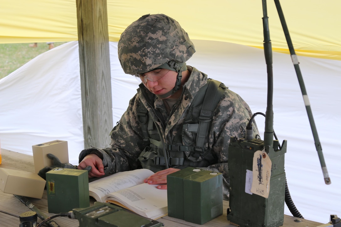 Army Spc. Ethan Estabrooks, a helicopter crew chief and mechanic with the Iowa Army National Guard’s Charlie Company, 2nd Battalion, 147th Aviation Regiment, reads from a technical manual during a SINCGARS radio communications event at the Iowa Best Warrior Competition at Camp Dodge in Johnston, Iowa, March 19, 2016. Each soldier was required to load a channel and communicate properly on the radio to pass the event. Iowa Army National Guard photo by Sgt. Andrew Shipley