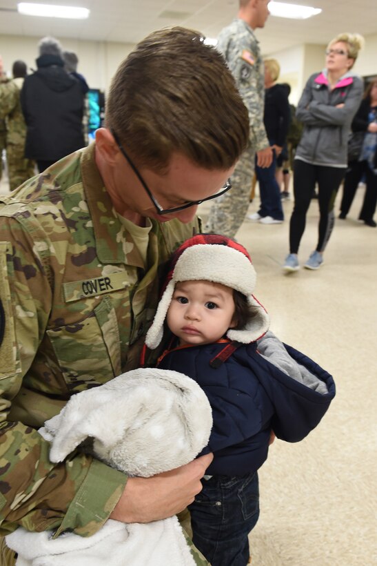 Staff Sgt. Michael Cover is reunited with his 11-month-old son, Ezra, after returning from a nearly year long deployment to Guantanamo Bay, Cuba with the 814th Military Police Company, March 23, 2016.
(U.S. Army photo by Spc. David Lietz/Released)