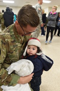 Staff Sgt. Michael Cover is reunited with his 11-month-old son, Ezra, after returning from a nearly year long deployment to Guantanamo Bay, Cuba with the 814th Military Police Company, March 23, 2016.
(U.S. Army photo by Spc. David Lietz/Released)