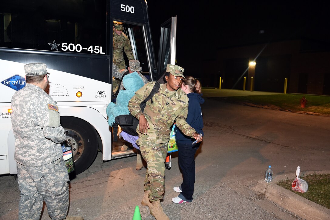 Capt. Ashana McPherson, Company Commander, 814th Military Police Company, steps off a bus early Wednesday morning at the Arlington Heights Reserve Center following a 10-month deployment to Naval Station, Guantanamo Bay, Cuba, March 23, 2016. The soldiers were greeted by their friends and family in a 2:00 am ceremony there.
(U.S. Army photo by Spc. David Lietz/Released)