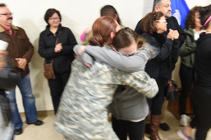 An Army Reserve soldier, assigned to the 814th Military Police Company, 327th MP Battalion, embraces in a hug during a Welcome Home ceremony at the Arlington Heights Reserve Center, March 23, 2016. The unit returned home early Wednesday morning after completing a 10-month deployment to Guantanamo Bay, Cuba.
(U.S. Army photo by Spc. David Lietz/Released)