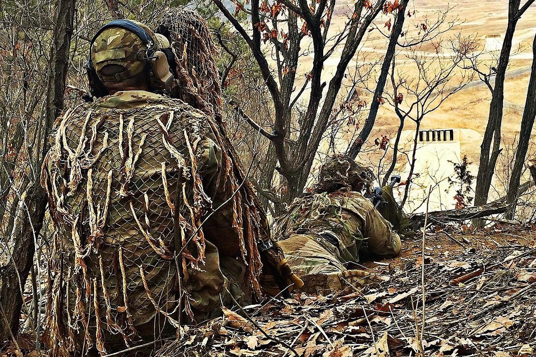 An Army sniper and spotter work to identify targets during a live-fire exercise at Rodriguez Live Fire Complex, South Korea, March 15, 2016. Army photo by Spc. Loren Keely