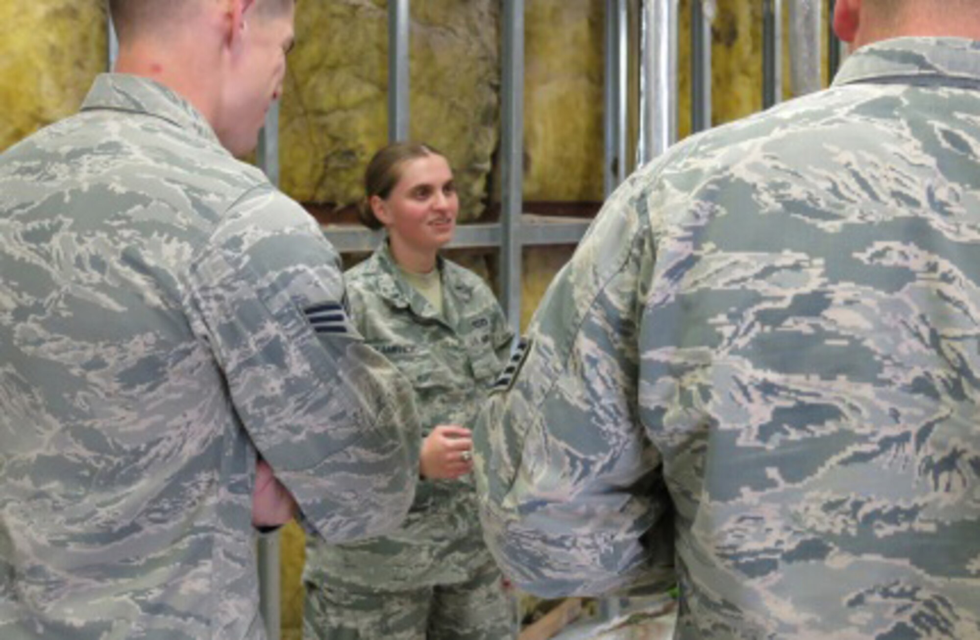 First Lt. Amela Kamencic, a former Bosnian refugee who now works as the 379th Expeditionary Civil Engineer Squadron operations engineering officer-in-charge, speaks with members of her team about ongoing renovations throughout Al Udeid Air Base, Qatar, March 16, 2016. (U.S. Air Force photo/Maj. Angela Webb)

