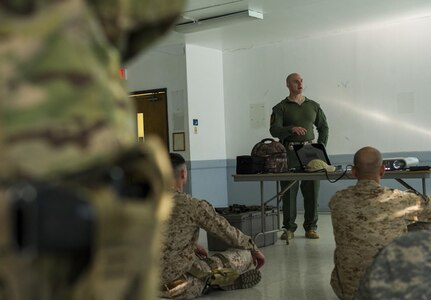 Grand Prairie Police Officer Nathan Lawless, patrol/SWAT, provides a block of instruction to U.S. Army Reserve Soldiers from the 607th Military Police Battalion, of the 200th MP Command, and Marines during a two-day joint training exercise in Mansfield, Texas, March 24. More than 15 service members partnered to share and learn police tactics and techniques. (U.S. Army photo by Staff Sgt. Shejal Pulivarti)