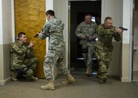 U.S. Army Reserve Soldiers from the 607th Military Police Battalion, of the 200th MP Command, practice clearing a room and eliminating the staged threat during a two-day joint training exercise conducted by the Grand Prairie Police Department in Mansfield, Texas, March 24. More than 15 service members, including Marines from the same Reserve Center, partnered to share and learn police tactics and techniques. (U.S. Army photo by Staff Sgt. Shejal Pulivarti)