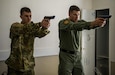 U.S. Army Reserve Spc. Austin Dunaway and Police Officer Matthew Dick, both  military police from the 607th Military Police Battalion, of the 200th MP Command, practice quick draw techniques during a two-day joint training exercise conducted by the Grand Prairie Police Department in Mansfield, Texas, March 24. More than 15 service members, including Marines from the same Reserve Center, partnered to share and learn police tactics and techniques. (U.S. Army photo by Staff Sgt. Shejal Pulivarti)