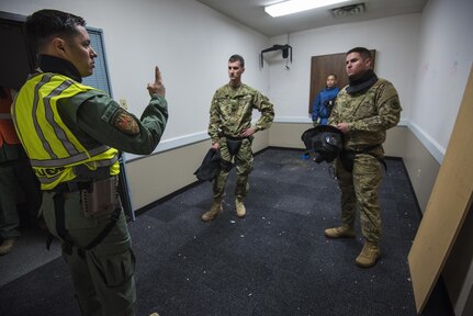 A police officer from the Grand Prairie Police Department provides instruction to U.S. Army Reserve Soldiers from the 607th Military Police Battalion, of the 200th MP Command, during a simulated round drill that tested skills learned during a two-day joint training exercise conducted by the GPPD in Mansfield, Texas, March 24. More than 15 service members, including Marines from the same Reserve Center, partnered to share and learn police tactics and techniques. (U.S. Army photo by Staff Sgt. Shejal Pulivarti)