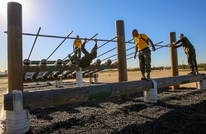 Recruits of Fox Company, 2nd Recruit Training Battalion, tackle a high obstacle during Obstacle Course II at Marine Corps Recruit Depot San Diego, March 24. The recruits were allowed to complete this obstacle by sliding down under a single bar or by pulling themselves up and sliding down two bars. Annually, more than 17,000 males recruited from the Western Recruiting Region are trained at MCRD San Diego. Fox Company is scheduled to graduate June 3.